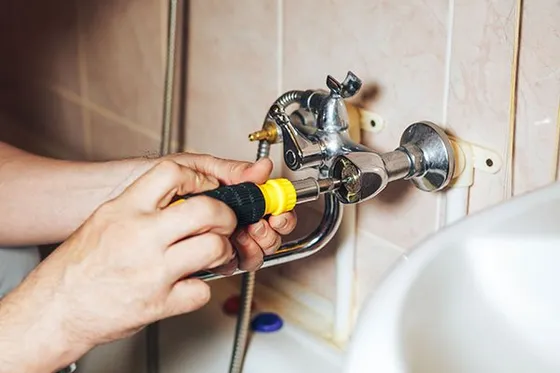 D&L Plumbing team working on the bathroom tub faucet in Dickinson County, MI D&L Plumbing team working on the bathroom tub faucet in Dickinson County, MI